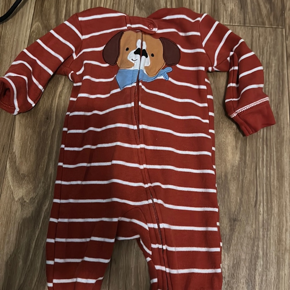 This is a Carter’s orange is reddish with a dog on the front footsie pajamas
